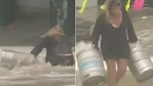 Mulher se joga em mar revolto para salvar barris de cerveja